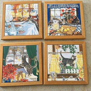 Four cat tile trivets or wall hangings.